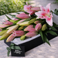 pink lilies in gift box
