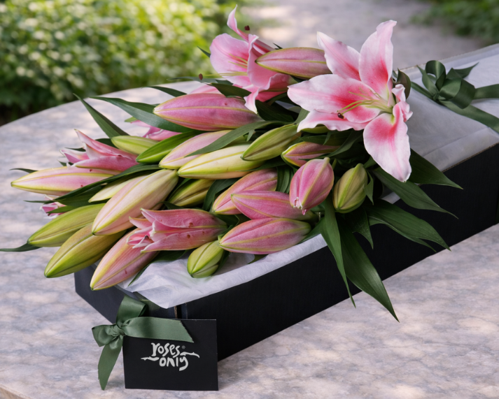 pink lilies in gift box
