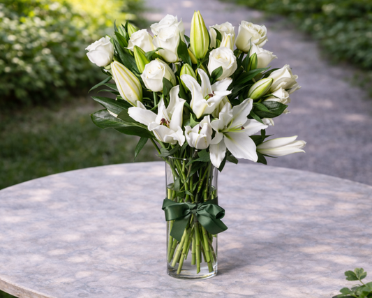 white lilies and white roses in a vase
