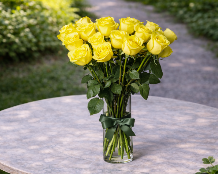 yellow long stemmed rose in a vase